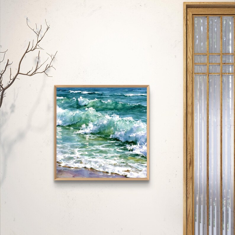 May include: A square framed painting depicting ocean waves crashing towards a sandy shore. The artwork features vibrant shades of turquoise, deep blue, and white sea foam, capturing the movement of water with visible brushstrokes and light.