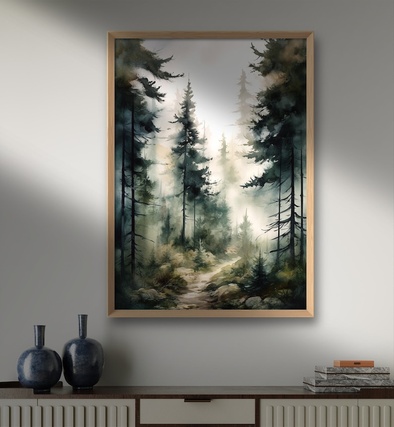May include: A framed watercolor painting of a forest path leading into a misty, green forest. The path is lined with tall, dark green trees and the light is soft and diffused.