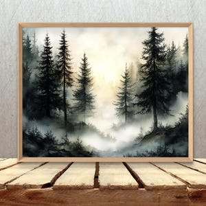 May include: A framed watercolor painting of a misty forest scene. Tall, dark green pine trees are silhouetted against a soft, golden light. The foreground features a layer of fog, creating depth and a serene atmosphere.