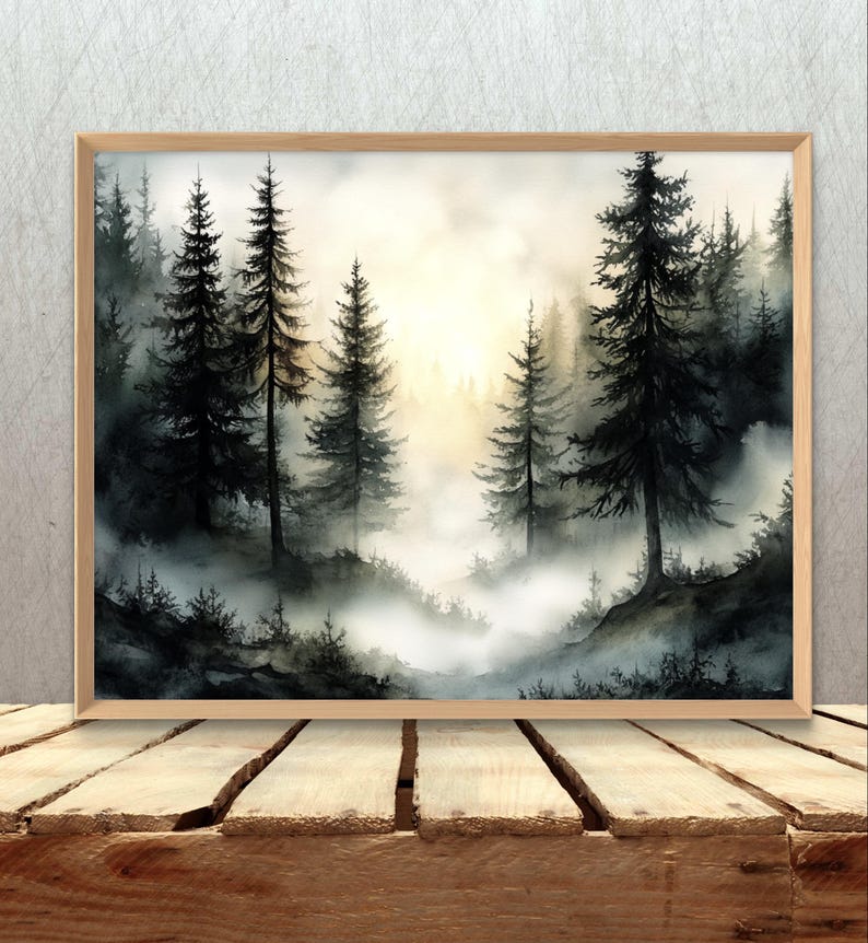 May include: A framed watercolor painting of a misty forest scene. Tall, dark green pine trees are silhouetted against a soft, golden light. The foreground features a layer of fog, creating depth and a serene atmosphere.