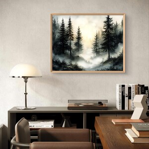 May include: A framed landscape art print featuring a misty forest scene with tall, dark evergreen trees. The artwork has a natural wood frame and a soft, atmospheric quality with a bright, golden light in the background.