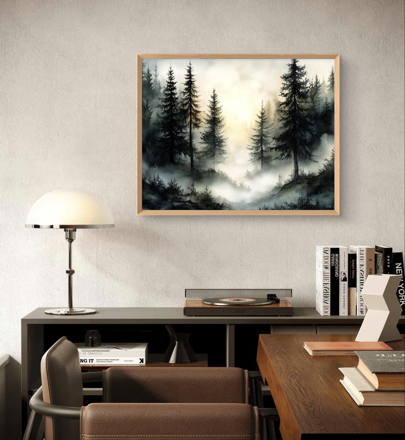 May include: A framed landscape art print featuring a misty forest scene with tall, dark evergreen trees. The artwork has a natural wood frame and a soft, atmospheric quality with a bright, golden light in the background.