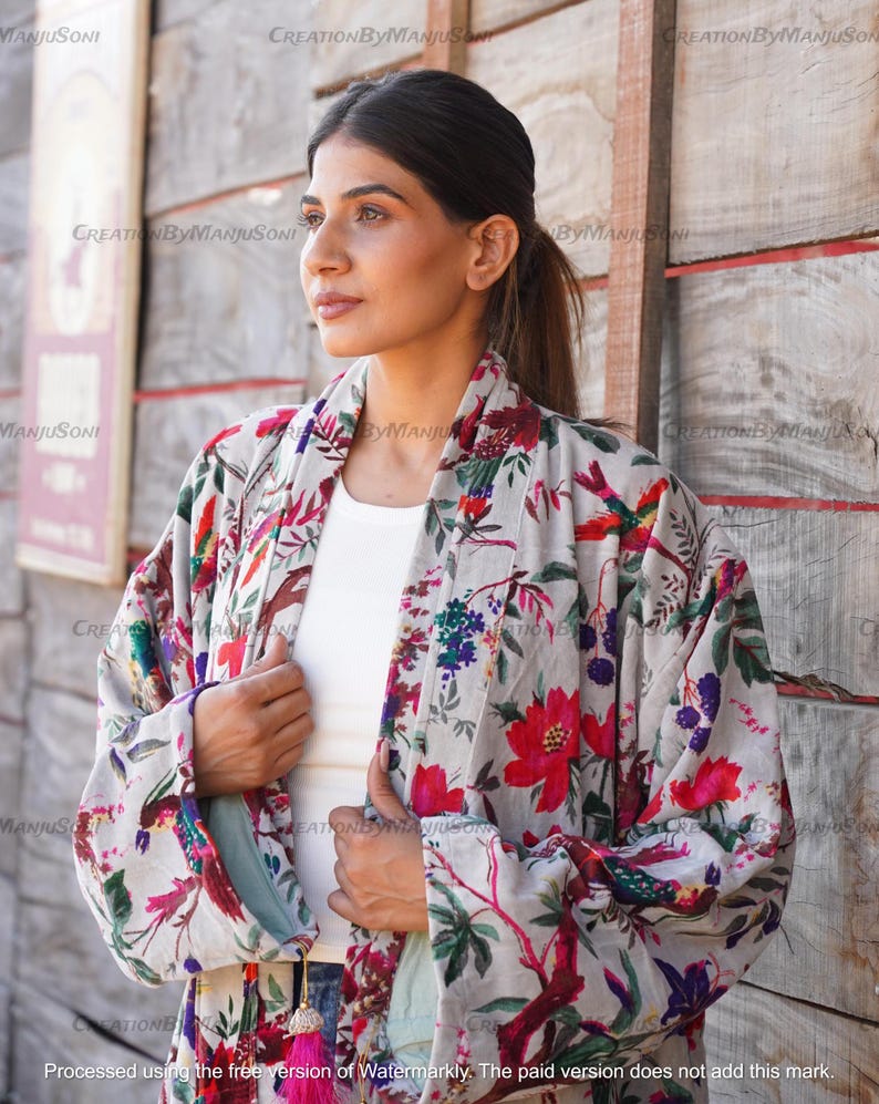 May include: A gray and white floral kimono with red and pink flowers and birds. The kimono has a long sleeve and a tie belt.
