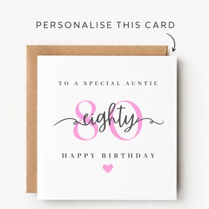 May include: A square white greeting card with a brown envelope featuring the text "PERSONALIZE THIS CARD" with an arrow. The card reads "TO A SPECIAL AUNTIE", "eighty" in script, "HAPPY BIRTHDAY", a pink number 80, and a small pink heart.