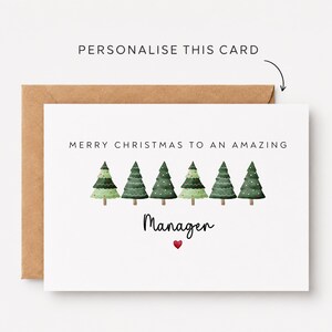 May include: A white greeting card with a brown envelope featuring the text "PERSONALIZE THIS CARD" with an arrow. The card displays the text "MERRY CHRISTMAS TO AN AMAZING Manager" above six watercolour-style green Christmas trees and a small red heart.