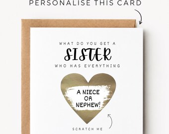 May include: A square white greeting card with a brown envelope featuring the text "WHAT DO YOU GET A SISTER WHO HAS EVERYTHING" and a gold heart-shaped scratch-off area revealing the text "A NIECE OR NEPHEW!" with the words "SCRATCH ME" below.
