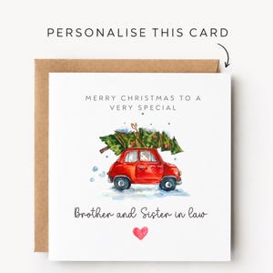May include: A square white greeting card with a brown envelope featuring a watercolor illustration of a red car carrying a Christmas tree on its roof. The text reads Merry Christmas to a very special Brother and Sister in law with a small red heart.