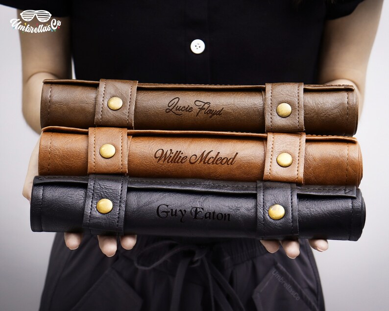 May include: Three brown leather cases with gold buckles and engraved names: Lucie Floyd, Willie McLeod, and Guy Eaton.
