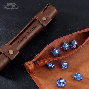May include: A brown leather dice rolling pouch with a zipper closure. The pouch is open and shows a set of iridescent dice with white numbers. The pouch is personalized with the name "George Collins".