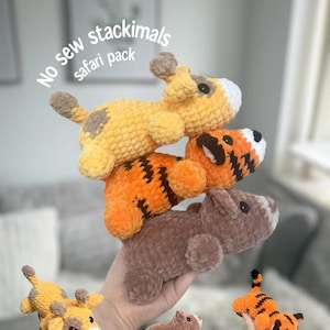 May include: Crocheted safari animal stackimals in yellow, orange, and brown. The stack includes a giraffe, tiger, and bear. The text "No sew stackimals safari pack" is visible.
