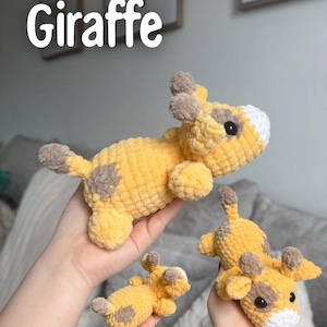 May include: Crocheted giraffe toys in various sizes. The giraffes are yellow with brown spots and accents, including the ears and tail. The text "Giraffe" is displayed in white. The toys are soft and plush.
