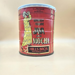 May include: Vintage Hills Bros. Java and Mocha coffee can. The red can features a yellow-clad figure and text that reads "Highest Grade Java and Mocha." The can is labeled as a 3 lb package and is from San Francisco, CA.