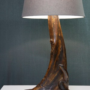 Handmade lamp made of driftwood and natural stone in a rustic style in a wide range of shades of brown.