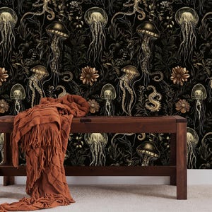 May include: A dark brown wooden bench with a brown throw blanket in front of a black and gold wallpaper featuring a repeating pattern of jellyfish and sea creatures.