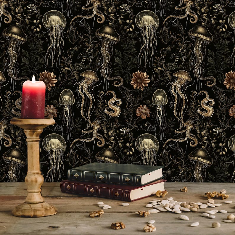 May include: A black background with a gold and white repeating pattern of jellyfish and floral designs. A lit candle on a wooden candlestick and two books are in the foreground.