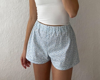Blue floral shorts with either a scrunchie or hair band made of 100% cotton