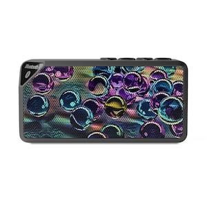 May include: A rectangular Bluetooth speaker with a colorful, abstract design of iridescent orbs. The speaker has a dark gray frame and a perforated front panel. The word "Bluetooth" is printed on the upper left corner.