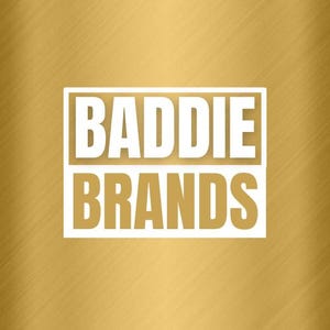 May include: A white rectangle with the text "BADDIE BRANDS" in black letters on a gold background.