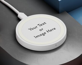 May include: A white wireless charging pad with a black cable. The pad has the text "Your Text or Image Here" written on it. The pad is sitting on a black surface.