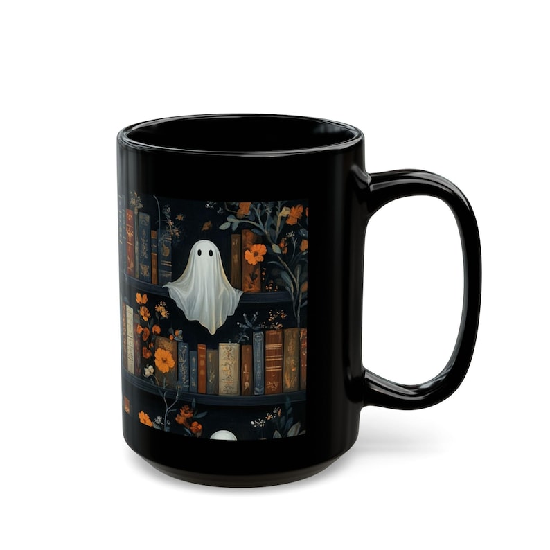 A black mug with a Halloween-themed design featuring a ghost, books, and flowers.