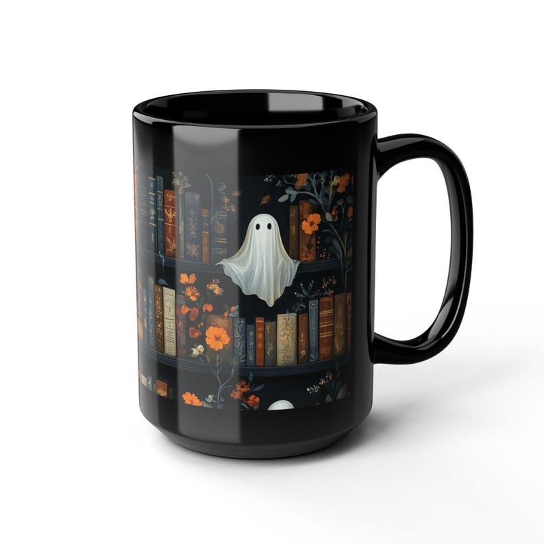 A black mug with a Halloween-themed design featuring a ghost floating above a bookshelf filled with books and flowers.
