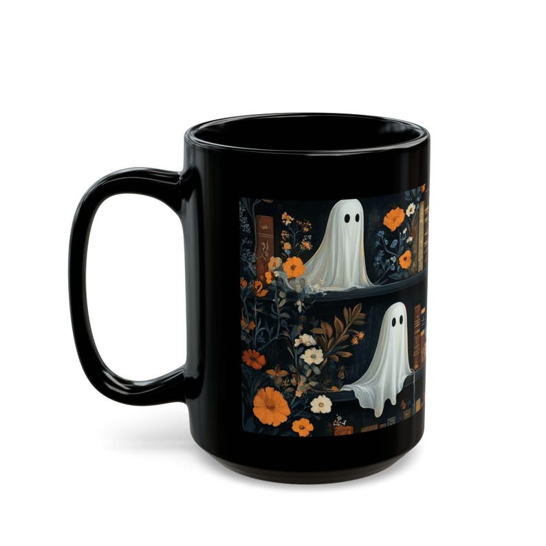 A black mug with a Halloween-themed design featuring a ghost surrounded by flowers and leaves.