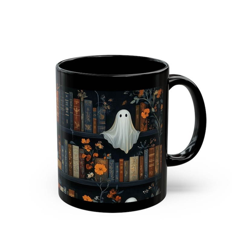 A black mug with a Halloween-themed design featuring a ghost floating above a bookshelf filled with books and flowers.