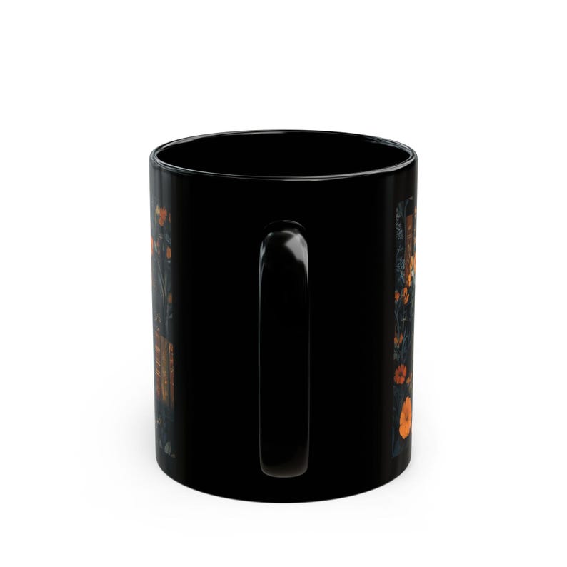 A black mug with a floral design on it.