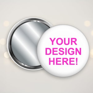 May include: A white button with a silver mirror back. The button has the text "YOUR DESIGN HERE!" printed in pink.
