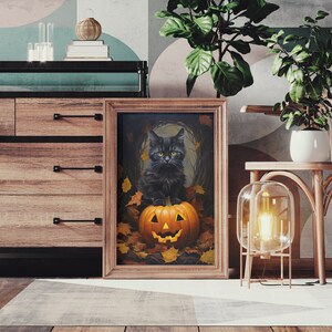 May include: A framed print of a black cat sitting inside a jack-o'-lantern with autumn leaves surrounding it.
