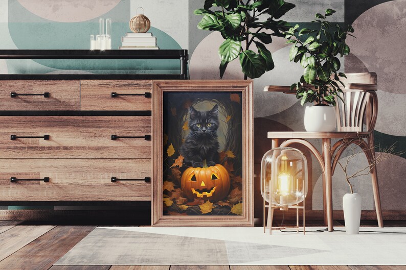 May include: A framed print of a black cat sitting inside a jack-o'-lantern with autumn leaves surrounding it.