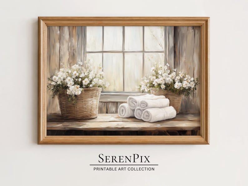 May include: A framed print of a serene interior scene. Two woven baskets overflowing with white flowers flank a window. Rolled white towels rest on a wooden surface. The print has a warm, neutral color palette.