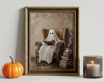 May include: A framed print shows a ghost reading a book in a brown armchair. A stack of books and a cup of tea are beside the chair. An orange pumpkin and a candle in a glass holder are in the foreground.