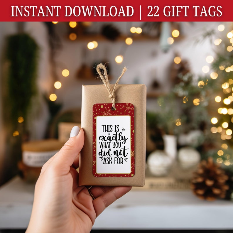 May include: Red and gold gift tag with the text "THIS IS exactly WHAT YOU did not ASK FOR" on a red background with gold snowflakes.