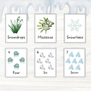 May include: A set of watercolour illustrations on white cards. The cards depict winter-themed images: snowdrops, mistletoe, a snowflake, four mittens, six ice skates, and seven blue hats. Each card has a corresponding word or number.