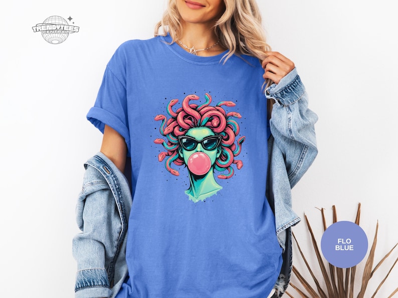 Flo Blue Comfort Colors tee with the Medusa graphic printed front and center. The washed blue tone gives the overall look a softer, vintage-worn feel. Great option for casual outfits.