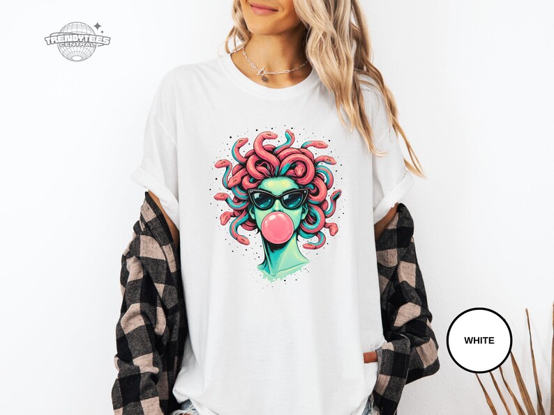 White Comfort Colors t-shirt with the Medusa portrait and pink bubblegum bubble printed in the center. The white base makes every color in the design look brighter and more detailed. Clean option for shoppers who like crisp, high-contrast graphics.
