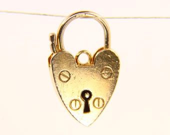 May include: A gold heart-shaped padlock charm with a keyhole and decorative screws. The charm is made of metal and has a shiny finish.