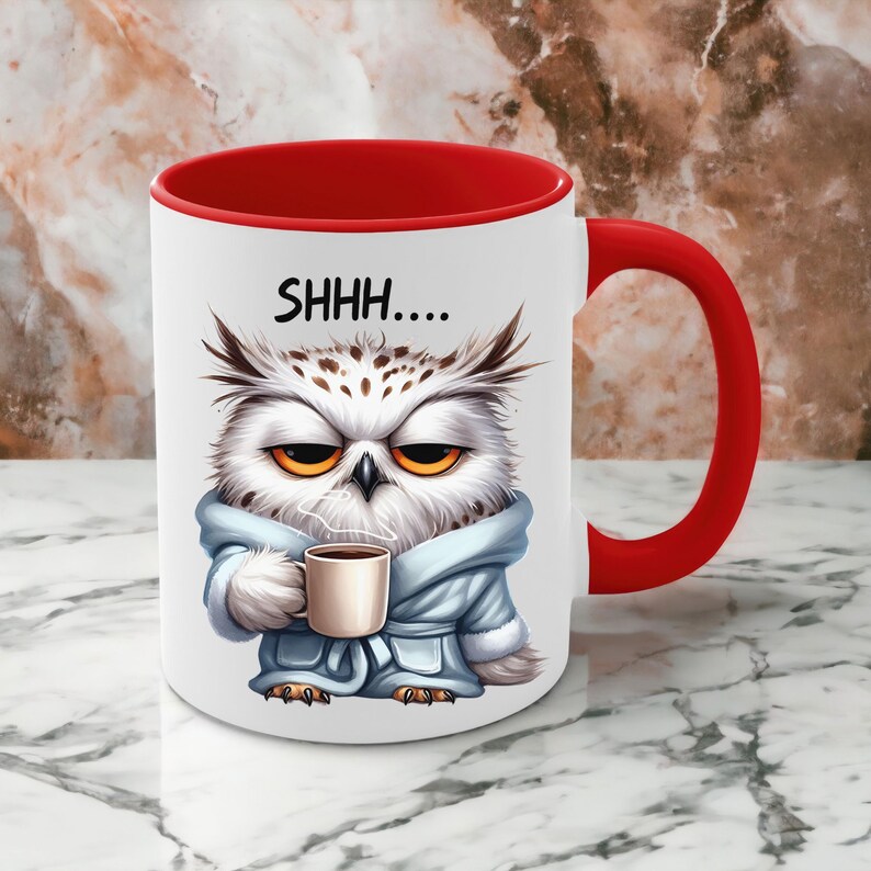 May include: White ceramic mug with a red interior and handle. The mug features a cartoon owl wearing a blue robe and holding a coffee cup. The text "SHHH...." is printed above the owl's head. The owl has yellow eyes and a grumpy expression.