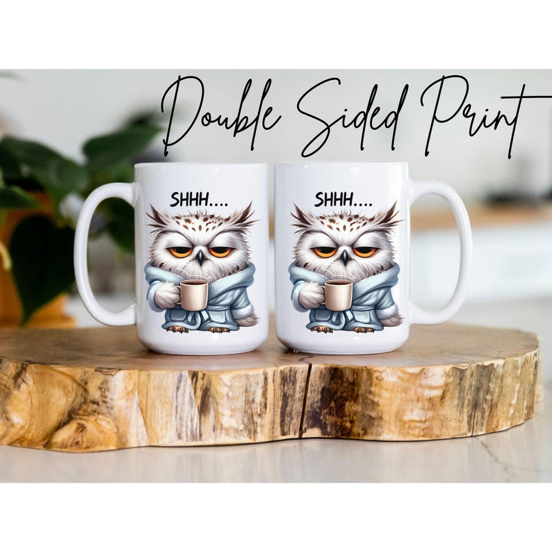 May include: Two white ceramic mugs with a double-sided print. Each mug features an illustration of an owl wearing a blue robe and holding a coffee cup. The text "SHHH...." is above the owl. The words "Double Sided Print" are written above the mugs.