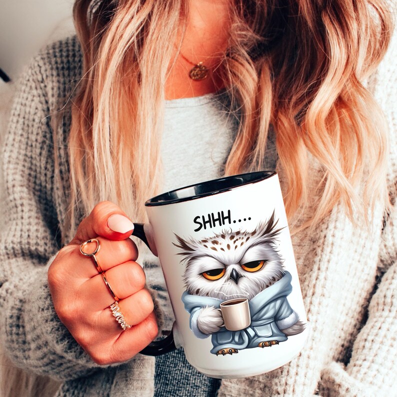 May include: White ceramic coffee mug with a black interior and handle. The mug features a cartoon owl wearing a blue robe and holding a coffee cup. The text "SHHH...." is printed above the owl's head.