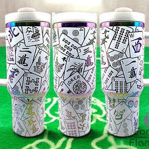 May include: Three white stainless steel travel mugs with a black and white mahjong tile pattern. The mugs have a rainbow iridescent finish and a black lid with a white handle.