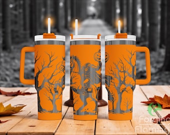 May include: Three orange insulated tumblers with white lids, handles, and straws. Each tumbler features a black and gray Halloween-themed design, including a headless horseman, trees, and a jack-o'-lantern. The tumblers are displayed on a wooden surface.
