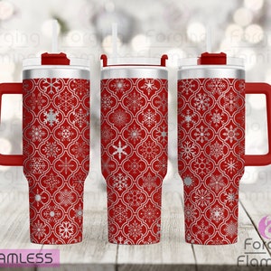 May include: Three red stainless steel tumblers with a white snowflake pattern. The tumblers have a lid and a handle.