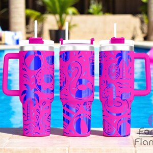 May include: Three pink insulated tumblers with handles, white lids, and straws. Each tumbler features a blue pattern of beach-themed icons, including flamingos, palm trees, and beach balls. The tumblers are set against a pool background.