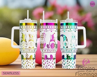 May include: Three white insulated tumblers with handles and straws. Each tumbler features a colorful Easter-themed design with gnomes and bunnies. The designs include pastel colors, floral accents, and the text "SEAMLESS" at the bottom.