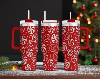 May include: Three red insulated tumblers with white and silver peppermint swirl designs. Each tumbler has a white lid, a red handle, and a white straw. The tumblers are on a wooden surface with a Christmas tree in the background.