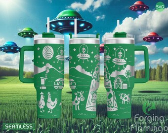 May include: Green travel mug with a handle, featuring a silver alien and spaceship design. The design includes farm animals, mountains, and a barn. The background shows flying saucers and a field. The mug has a white straw and a green lid.