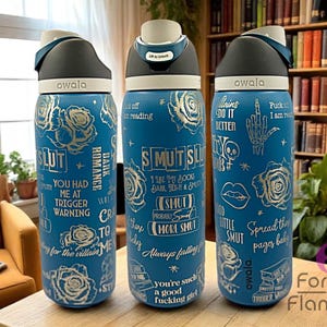 May include: Three blue Owala water bottles with silver text and rose illustrations. The bottles have various phrases like "SMUT" and "Dark Romance". Each bottle has a black and white lid.