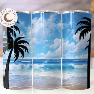 May include: A set of three stainless steel tumblers with a beach scene design. The design features a blue sky with white clouds, ocean waves, and a sandy beach. Black palm tree silhouettes frame the scene. The tumblers include 20 free designs.